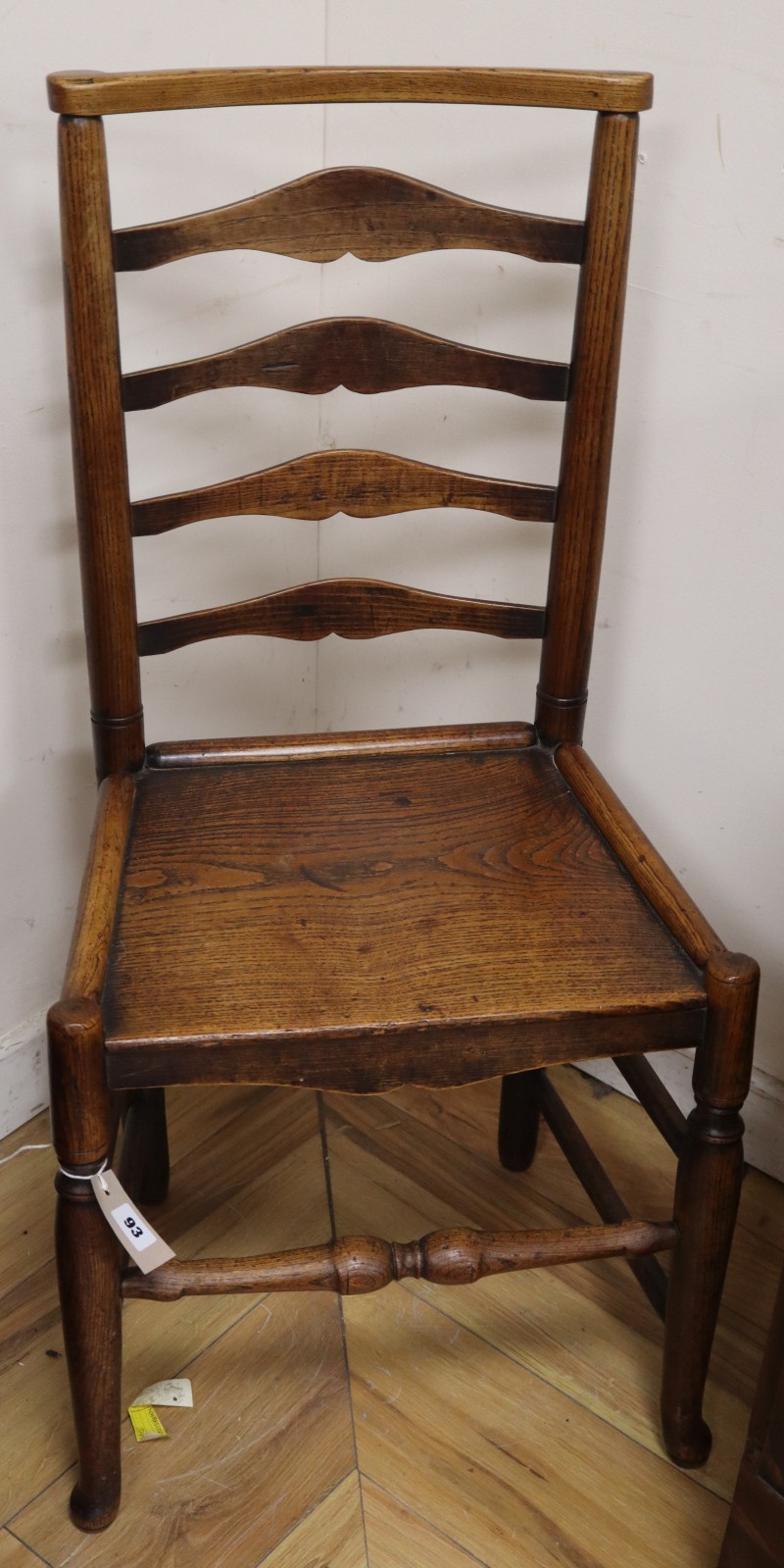 An 18th/19th century ash and elm ladder-back chair